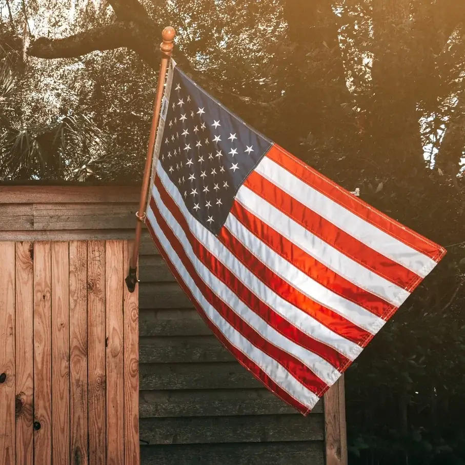 American flag mounted on a wood fence installed by Star City Fence Co