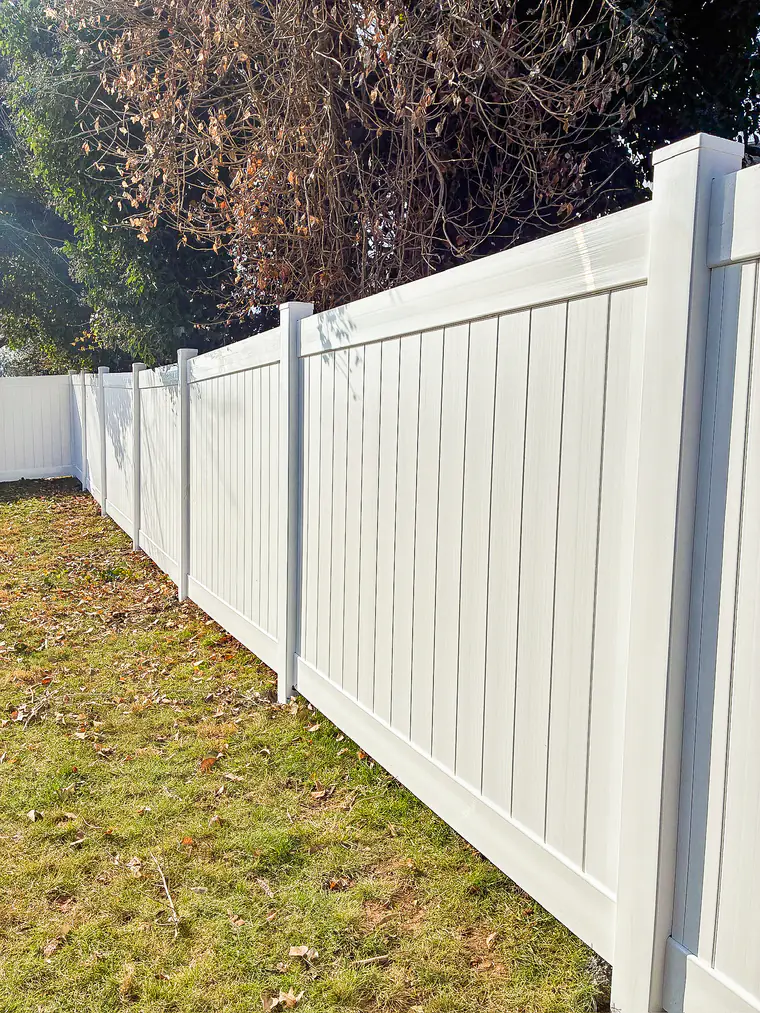 White vinyl privacy fence along the side of a Roanoke home