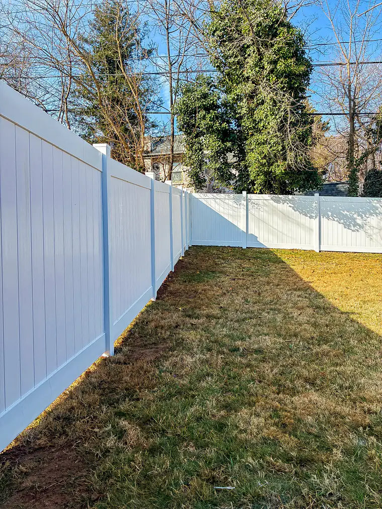 White vinyl privacy fence turning a corner in a Roanoke backyard