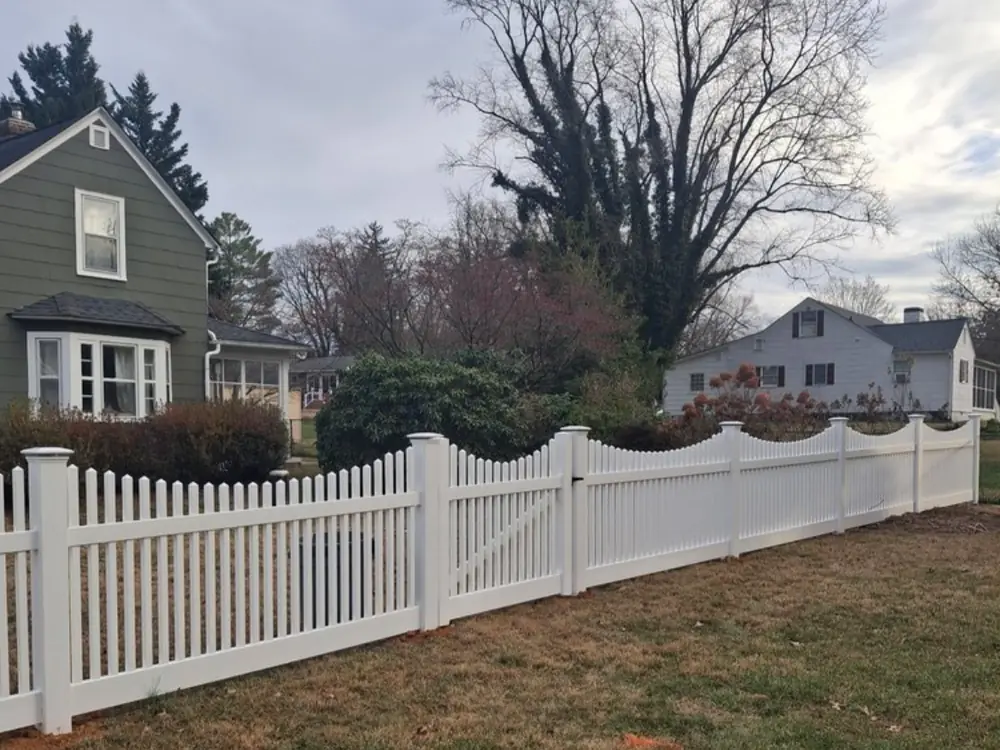 White scalloped vinyl picket fence with gate