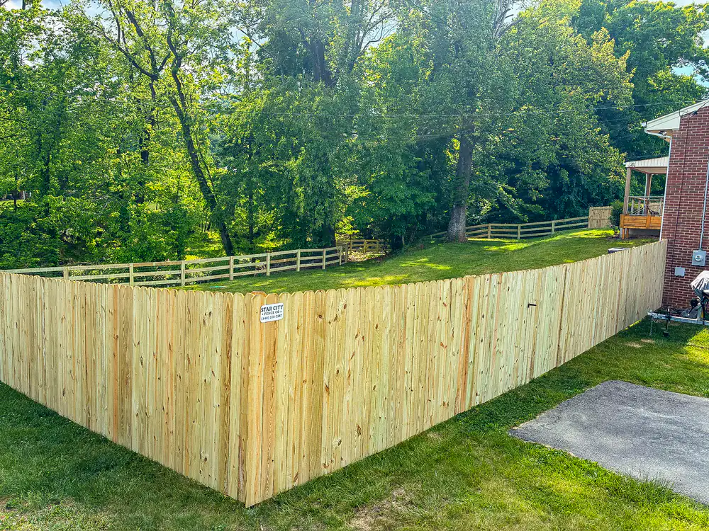 Corner of a new wood privacy fence enclosing a wooded Roanoke backyard