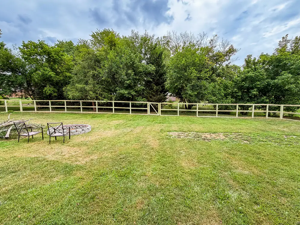 Three-rail wood ranch fence enclosing an open pasture near Roanoke