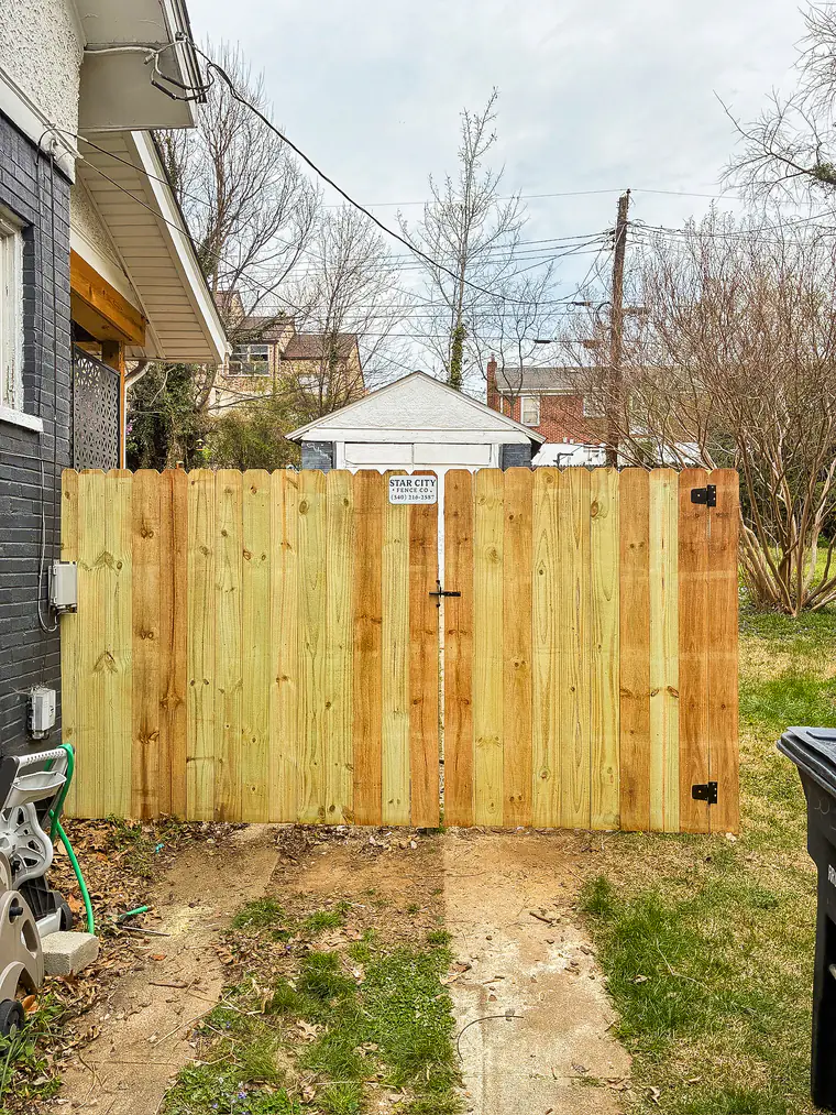 Fresh wood privacy gate with Star City Fence Co job sign in Roanoke