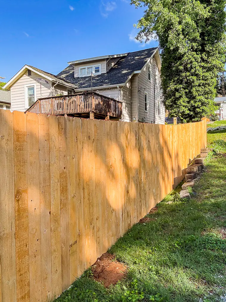 Wood privacy fence in warm evening light beside a Roanoke home